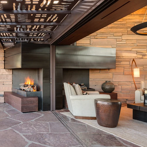 Architectural shade panels above a fireplace seating area