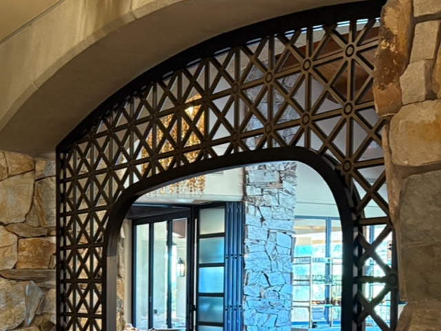 Decorative composite panel framing an arched stone doorway